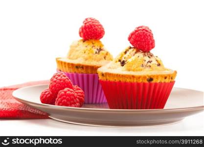 Photo of cupcakes with raspberries over white isolated background
