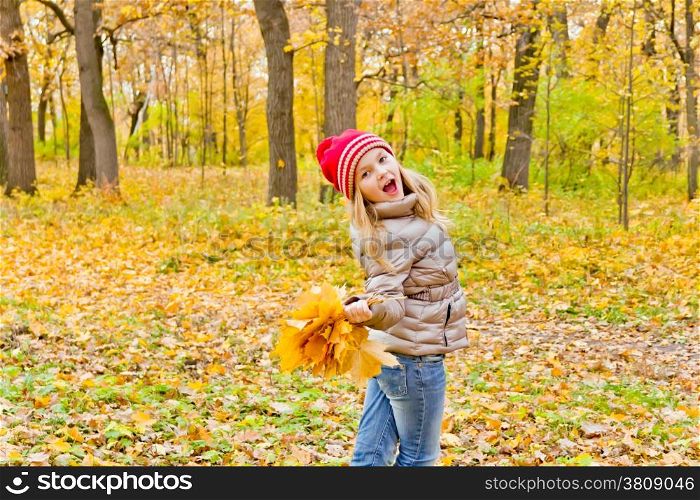 Photo of cute dancing girl in autumn