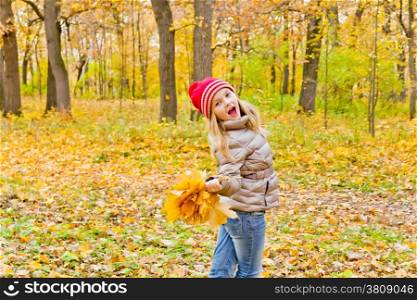 Photo of cute dancing girl in autumn