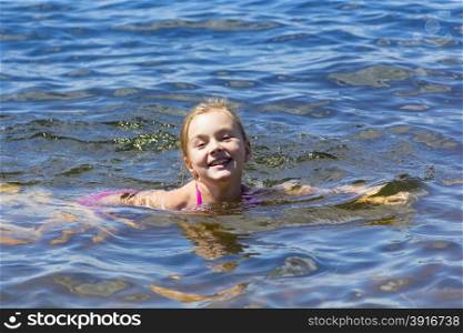 Photo of cute girl bathing in the sea