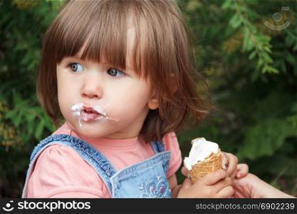 Photo of cute girl eating icecream in summer