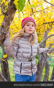 Photo of cute girl in autumn sit on tree