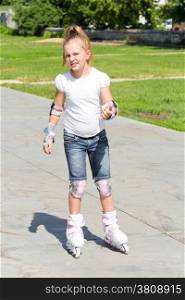 Photo of cute girl on roller skates in summer