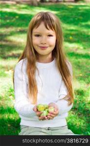 Photo of cute girl with apples in summer