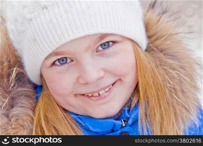 Photo of cute girl with blue eyes in white hat