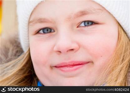 Photo of cute girl with blue eyes in white hat