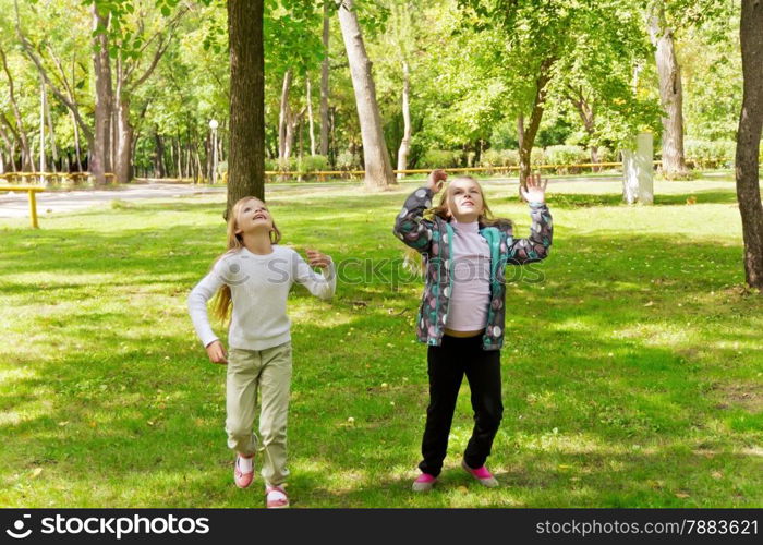 Photo of cute jumping two girls in summer