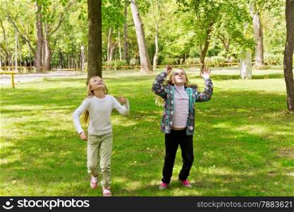 Photo of cute jumping two girls in summer