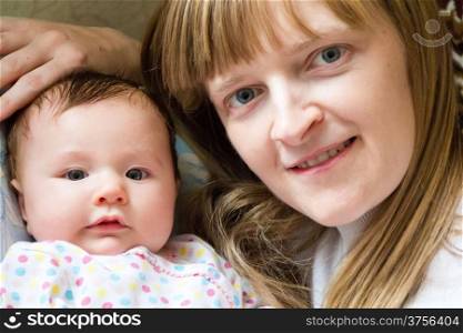 Photo of cute newborn infant girl and mother