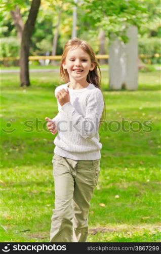 Photo of cute running girl in summer