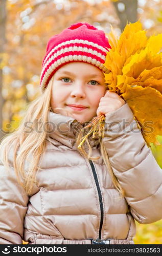 Photo of cute smiling girl in autumn