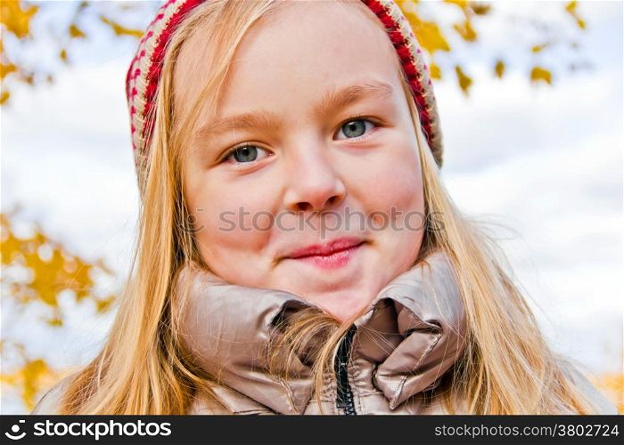 Photo of cute smiling girl in autumn