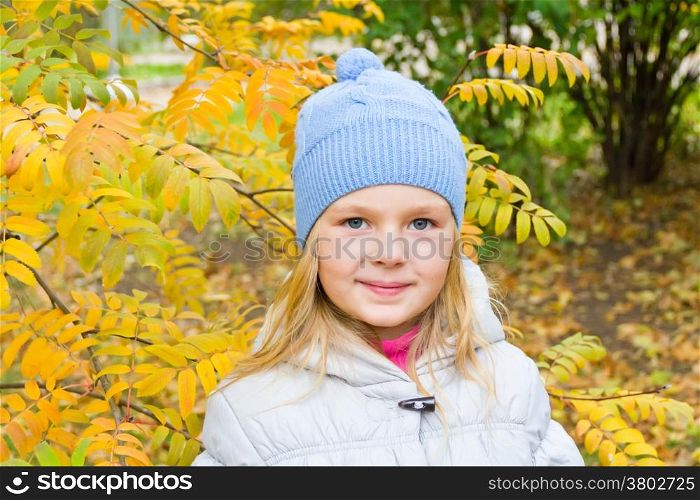 Photo of cute smiling girl in autumn