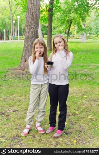 Photo of cute two eating blond girls