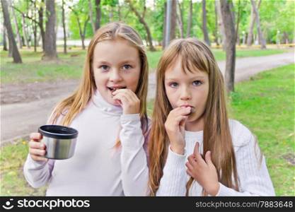 Photo of cute two eating blond girls