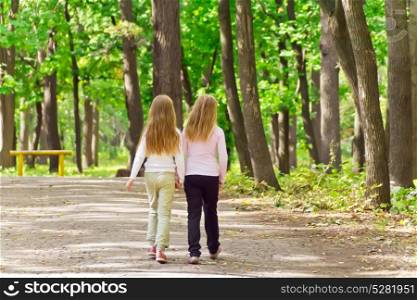 Photo of cute two girls walking in park