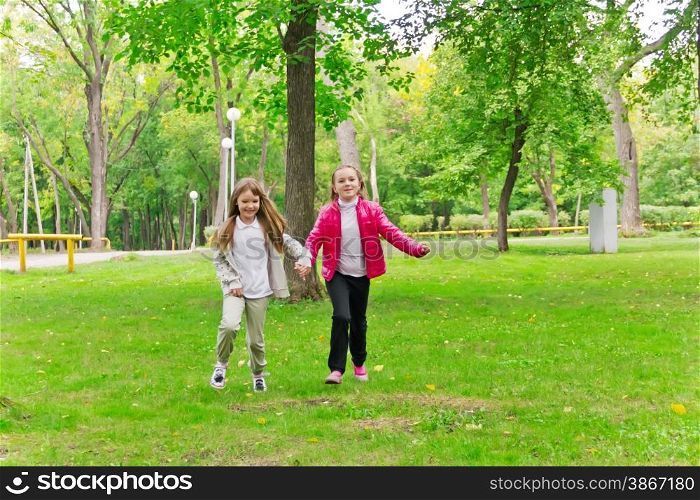 Photo of cute two running girls in summer