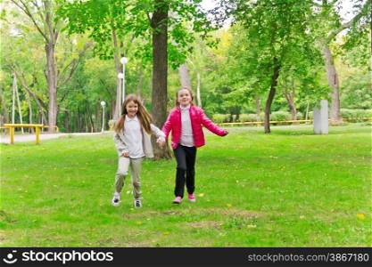 Photo of cute two running girls in summer