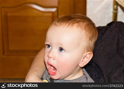 Photo of cute yawning baby boy 1 year