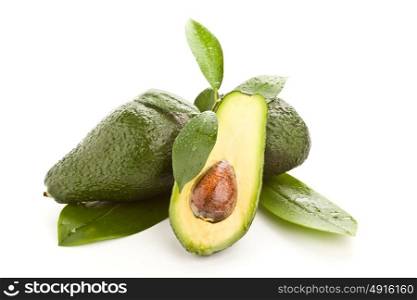 photo of cutted avocado fruit with green leaves on white isolated background