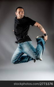 photo of dancer who is jumping high performing his movement