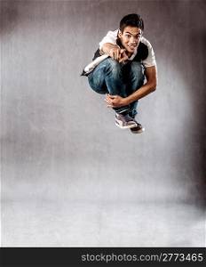 photo of dancer who is jumping high performing his movement