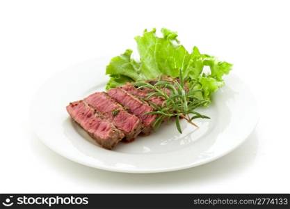 photo of delicious and pefect cooked beaf steak with rosemary and lettuce