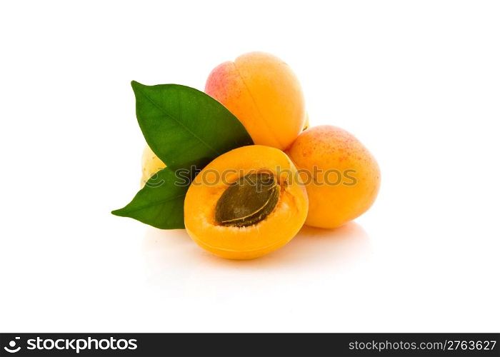 photo of delicious apricot with leaves on white background