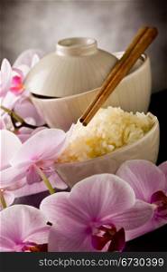 photo of delicious asian rice dish with orchid flowers around