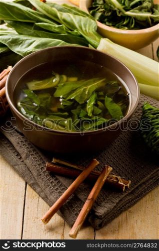 photo of delicious beet soup with vegetables on wooden table