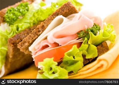 photo of delicious big cheese and ham sandwich with lettuce on white isolated background