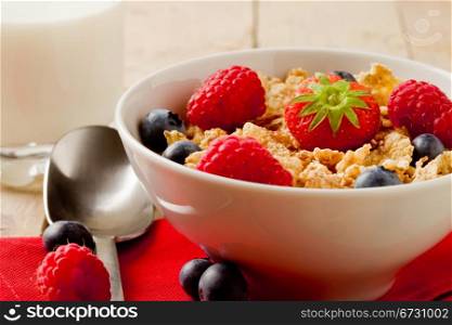 photo of delicious breafast made of corn flakes with berries and fresh milk