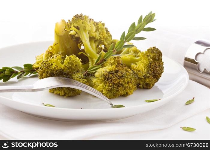 photo of delicious broccoli on white background with spices and olive oil