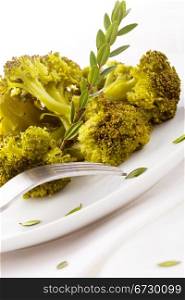 photo of delicious broccoli on white background with spices and olive oil