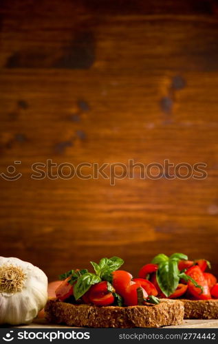 photo of delicious bruschetta appetizer with fresh cutted tomatoes and basil