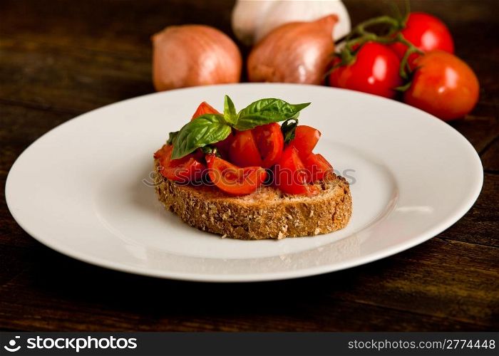 photo of delicious bruschetta appetizer with fresh cutted tomatoes and basil