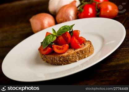 photo of delicious bruschetta appetizer with fresh cutted tomatoes and basil