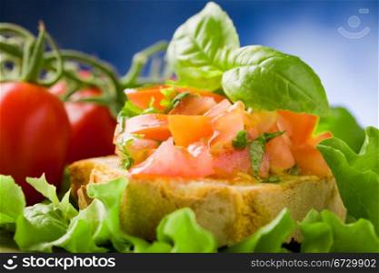 photo of delicious bruschetta appetizer with tomatoes and basil
