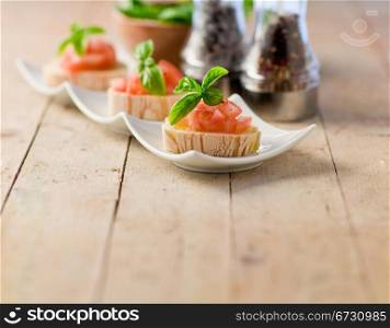 photo of delicious bruschetta with tomatoes on wooden table
