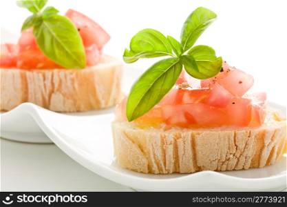 photo of delicious bruschetta with tomatoes on wooden table on isolated background