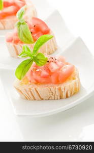 photo of delicious bruschetta with tomatoes on wooden table on isolated background