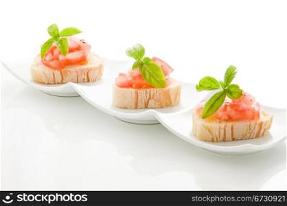 photo of delicious bruschetta with tomatoes on wooden table on isolated background