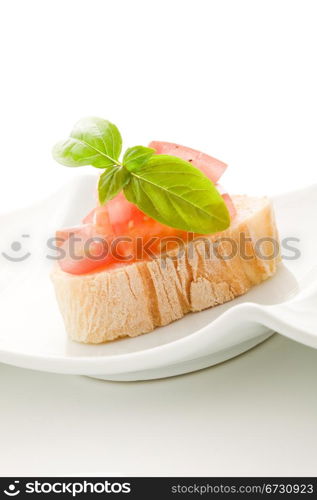 photo of delicious bruschetta with tomatoes on wooden table on isolated background