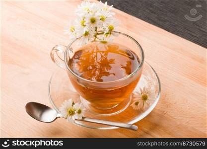 photo of delicious chamomile tea with marguerite reflecting on the tea
