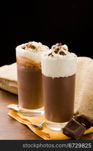 photo of delicious chocolate pudding with cream and chocolate chips