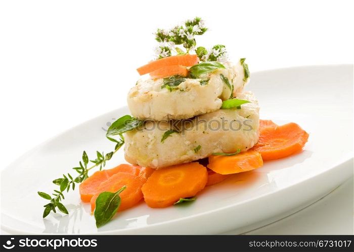photo of delicious cod over carrots on isolated white background