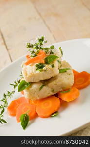 photo of delicious cod over carrots with fresh oregano and basil