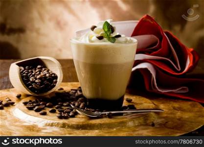 photo of delicious coffee beverage with whipped cream and coffee beans