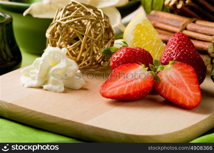 photo of delicious cutted strawberries with whipped cream