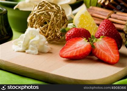 photo of delicious cutted strawberries with whipped cream